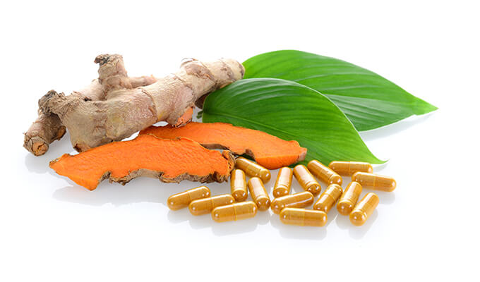 Ginger and pills on leaves
