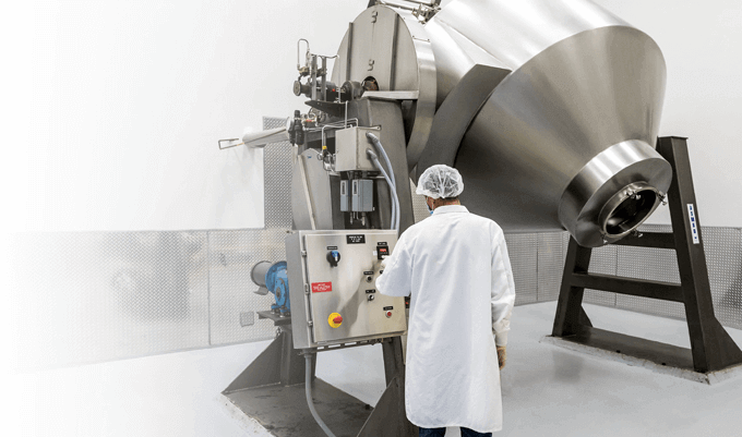 NAI facility worker operating supplement production blender